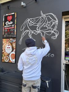 Custom hand-painted Toro Nero mural at Mona Vale restaurant by Fineline Painting